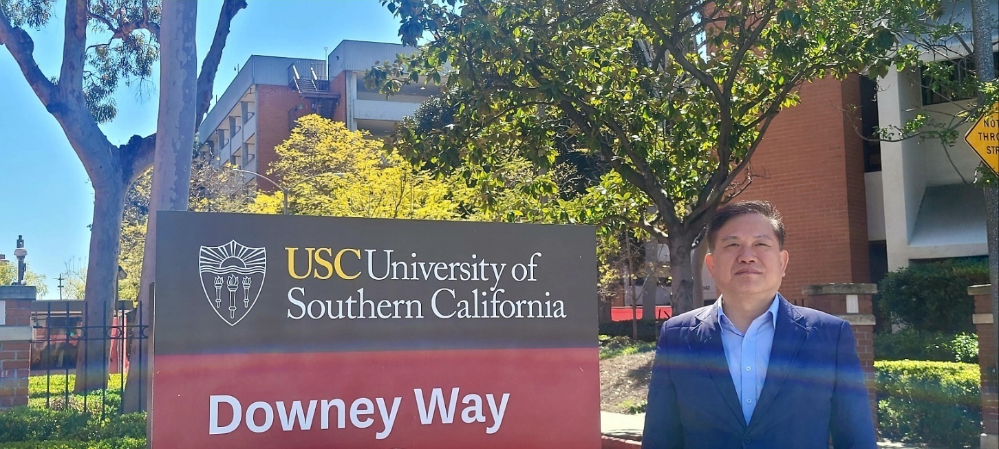 USC University of Southern California 표지판 앞에 선 이편한치과 원장